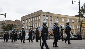 Chicago police officers respond to rioting near West Madison Street and South Karlov Avenue on the West Side, of Chicago, Monday, Aug. 10, 2020.  (Ashlee Rezin Garcia/Chicago Sun-Times via AP)