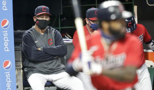 Cleveland Indians manager Terry Francona, left, watches as Cleveland Indians&#x27; Delino DeShields bats in the fifth inning in a baseball game against the Chicago Cubs, Tuesday, Aug. 11, 2020, in Cleveland. (AP Photo/Tony Dejak)