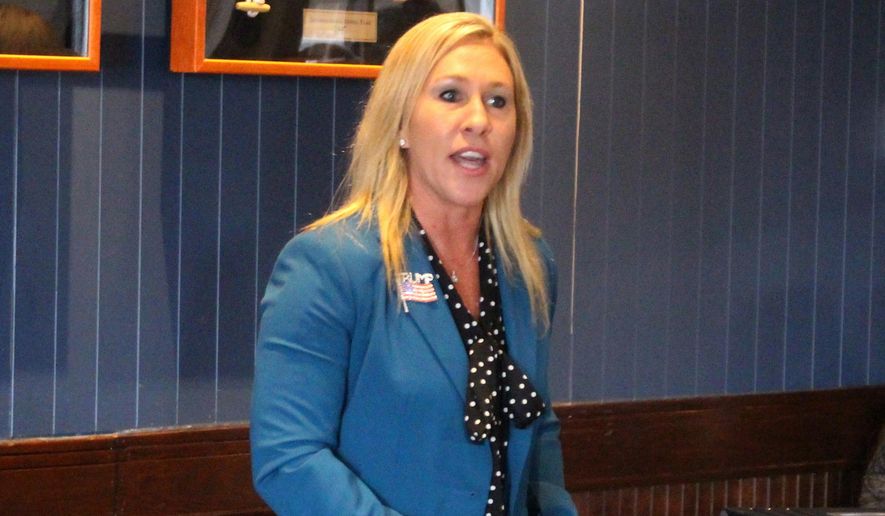 In this March 3, 2020, file photo, Republican Marjorie Taylor Greene speaks to a GOP women&#x27;s group in Rome, Ga. Greene, criticized for promoting racist videos and adamantly supporting the far-right QAnon conspiracy theory, has won the GOP nomination for northwest Georgia&#x27;s 14th Congressional District. (John Bailey/Rome News-Tribune via AP, File)