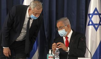 FILE - In this June 7, 2020 file photo, Israeli Prime Minister Benjamin Netanyahu, right, speaks with Defense Minister Benny Gantz, both wearing protective mask due to the ongoing coronavirus pandemic during the weekly cabinet meeting in Jerusalem. When  Netanyahu and his rival, Gantz, agreed to form an “emergency” government in May after three bitter, and ultimately deadlocked, election campaigns, the goal was to stabilize Israeli politics in the face of a global pandemic. Less than 100 days later their fractious coalition government appears to be headed toward collapse as Israel grapples with a raging coronavirus outbreak, an economic calamity and a wave of public protests. (Menahem Kahana/Pool Photo via AP, File)