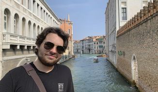 This 2019 photo provided by Mercedes Lemp shows Duncan Lemp in Venice, Italy. A conservative legal group has sued a Maryland police department for copies of any body camera videos of the fatal shooting of Lemp, whose family says he was asleep when police opened fire. Judicial Watch&#39;s lawsuit says the Montgomery County Police Department has failed to respond to its public records request for videos of the March 12 shooting of 21-year-old Duncan Lemp. The department hasn&#39;t said whether any such videos exist. (Mercedes Lemp via AP, File)