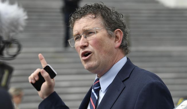 In this March 27, 2020, photo, Rep. Thomas Massie, Kentucky Republican, talks to reporters before leaving Capitol Hill in Washington. (AP Photo/Susan Walsh) **FILE**