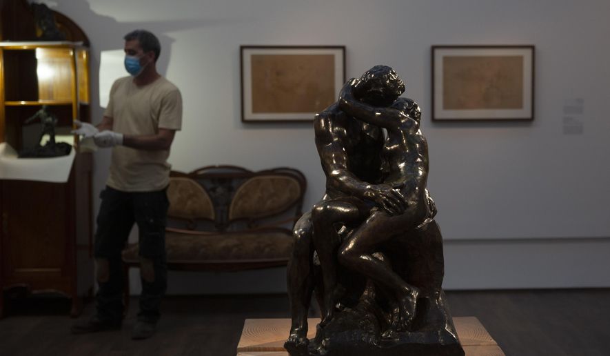 Auguste Rodin's "The Kiss," is on display in a gallery of the Israel Museum after five months in storage during closures due to the coronavirus pandemic, in Jerusalem, Tuesday, Aug. 11, 2020. The Israel Museum, the country's largest cultural institution, is returning the priceless Dead Sea scrolls and other treasured artworks to its galleries ahead of this week's reopening to the public. (AP Photo/Maya Alleruzzo)