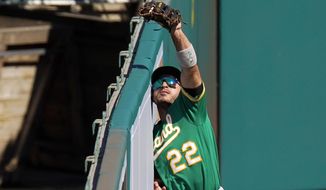 Oakland Athletics center fielder Ramon Laureano makes a catch at the wall on a ball hit by Los Angeles Angels&#39; Brian Goodwin during the seventh inning of a baseball game Wednesday, Aug. 12, 2020, in Anaheim, Calif. (AP Photo/Mark J. Terrill)
