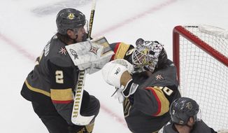 Vegas Golden Knights goalie Robin Lehner (90) makes a save as Zach Whitecloud (2) defends during the third period against the Chicago Blackhawks in Game 1 of an NHL hockey Stanley Cup first-round playoff series, Tuesday, Aug. 11, 2020, in Edmonton, Alberta. (Jason Franson/The Canadian Press via AP)