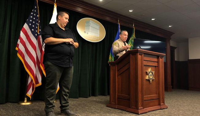 Los Angeles County Sheriff Alex Villanueva, right, announces the rollout of body-worn cameras for deputies during a news conference in Los Angeles on Wednesday, Aug. 12, 2020. Villanueva said 1,200 deputies in five patrol stations will receive the body cameras beginning Oct. 1.  (AP Photo/Stefanie Dazio)