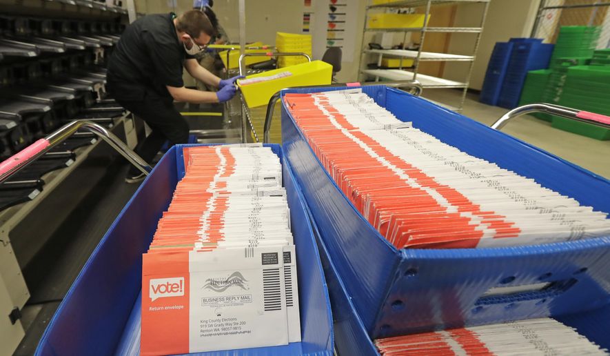 FILE - In this Aug. 5, 2020, file photo, vote-by-mail ballots are shown in sorting trays at the King County Elections headquarters in Renton, Wash., south of Seattle. Washington state saw its highest primary turnout in more than five decades, with 55% of the state's 4.6 million voters returning ballots for last week's election. While the final turnout number won't be known until Aug. 20, when the election is certified, as of Tuesday, Aug. 11, 2020, nearly 53% of the ballots have been processed, with just over 53,000 remaining. (AP Photo/Ted S. Warren, File)