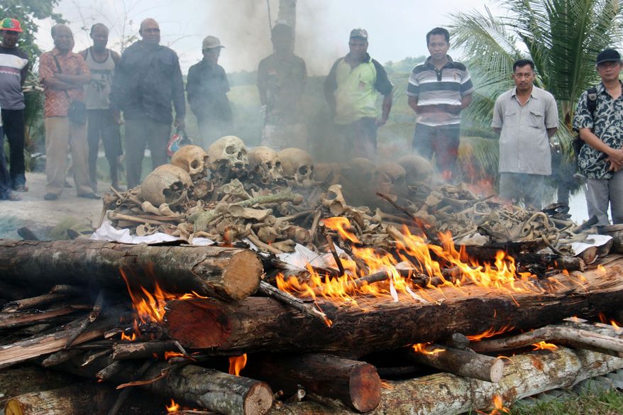 People gather for the cremation ceremony for Japanese war dead in World War II, in Papua province, Indonesia, March, 2013. Seventy-five years after the end of World War II, more than 1 million Japanese war dead are scattered throughout Asia, where the legacy of Japanese aggression still hampers recovery efforts.  The missing Japanese make up about half of the 2.4 million soldiers who died overseas during Japan’s military rampage across Asia in the early 20th century. (Kyodo News via AP)