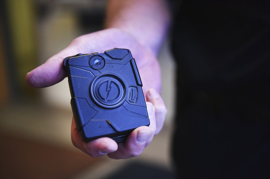 In this June 12, 2018, photo, Mitchell, S.D., Assistant Police Chief Michael Koster shows a first-generation body camera at the police department in Mitchell, S.D.  The U.S. Department of Homeland Security on August 4, 2021, announced that it has outfitted its first group of Border Patrol agents with body cameras as part of a push to get 6,000 cameras into the field by the end of this year. (Briana Sanchez/The Argus Leader via AP, File)/The Argus Leader via AP) **FILE**