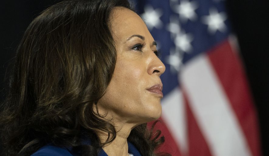 Democratic presidential candidate former Vice President Joe Biden&#39;s running mate Sen. Kamala Harris, D-Calif., looks to Biden during a campaign event at Alexis Dupont High School in Wilmington, Del., Wednesday, Aug. 12, 2020. (AP Photo/Carolyn Kaster)