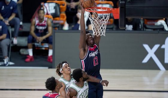 Washington Wizards&#39; Thomas Bryant (13) dunks during the first half of an NBA basketball game against the Boston Celtics Thursday, Aug. 13, 2020 in Lake Buena Vista, Fla. (AP Photo/Ashley Landis, Pool)