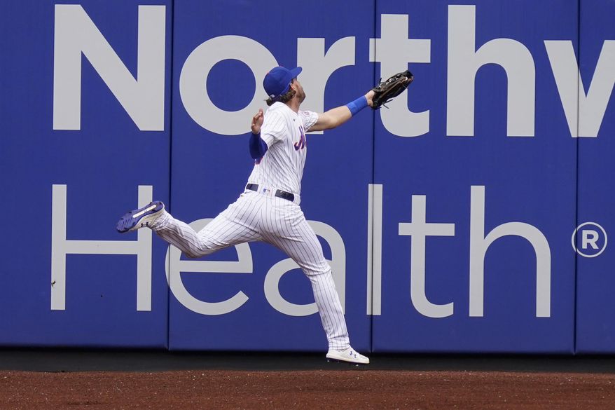 New York Mets left fielder Jeff McNeil injures himself while catching a fly ball during the first inning of a baseball game against the Washington Nationals at Citi Field, Thursday, Aug. 13, 2020, in New York. (AP Photo/Seth Wenig)