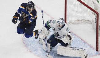 Vancouver Canucks goalie Jacob Markstrom (25) makes a save as St. Louis Blues&#39; Brayden Schenn (10) jumps during the second period in Game 1 of an NHL hockey Stanley Cup first-round playoff series, Wednesday, Aug. 12, 2020, in Edmonton, Alberta. (Jason Franson/The Canadian Press via AP)