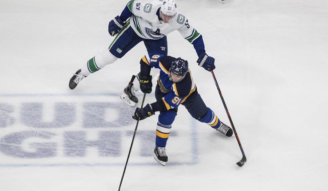 Vancouver Canucks&#x27; Tyler Myers (57) chases St. Louis Blues&#x27; Vladimir Tarasenko (91) during the second period in Game 1 of an NHL hockey Stanley Cup first-round playoff series, Wednesday, Aug. 12, 2020, in Edmonton, Alberta. (Jason Franson/The Canadian Press via AP)