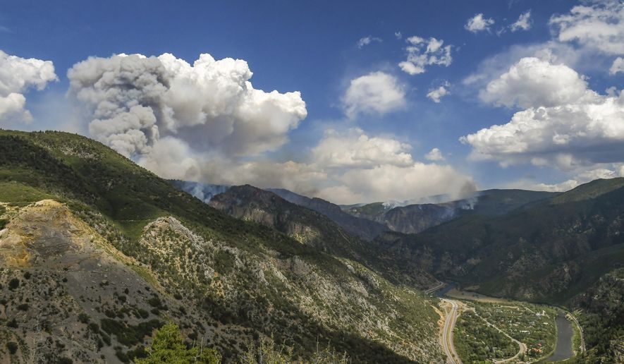 Smoke billows from the Grizzly Creek Fire above No Name Canyon and on the south side of the Colorado River above Glenwood Canyon on Wednesday, Aug. 12, 2020, just outside of Glenwood Springs, Colo. The fire started 5 miles east of Glenwood Springs on Monday, when large flames in the highway's median spread to the north of the highway. (Chelsea Self/Glenwood Springs Post Independent via AP)