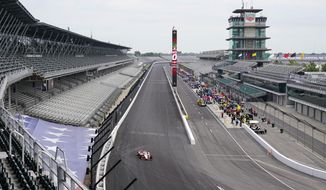 Drivers head to the track as practice opened for the Indianapolis 500 auto race at Indianapolis Motor Speedway in Indianapolis, Wednesday, Aug. 12, 2020. (AP Photo/Michael Conroy)