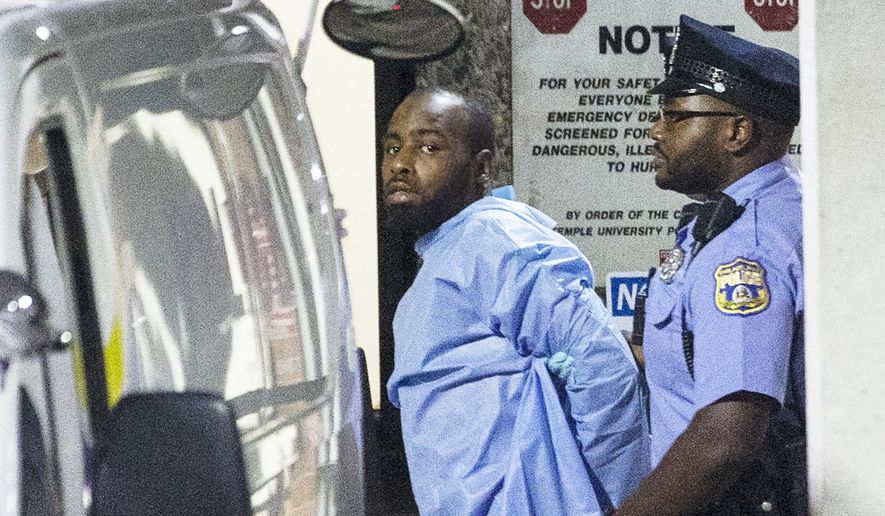 Police take shooting suspect, Maurice Hill, into custody after a standoff with police that wounded several police officers, in Philadelphia early Thursday, Aug. 15, 2019. The Philadelphia man charged with shooting six police officers during an hours-long standoff last summer, was held for trial Thursday, Aug. 13, 2020 on a third set of charges stemming from the incident. (Elizabeth Robertson/The Philadelphia Inquirer via AP)