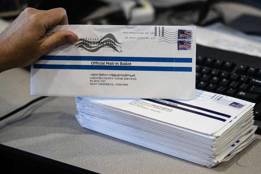 In this May 28, 2020, photo, mail-in primary election ballots are processed at the Chester County Voter Services office in West Chester, Pa. (AP Photo/Matt Rourke) **FILE**
