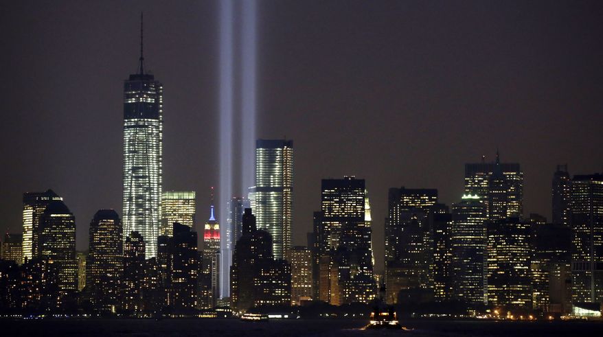 In this Wednesday, Sept. 11, 2013, file photo, the twin beams of the annual Tribute in Light commemorating the Sept. 11, 2001, terrorist attacks shine amid the city's skyline, in New York. In an announcement made Friday, Aug. 14, 2020, plans are back on to beam twin columns of light into the Manhattan sky to represent the World Trade Center during the anniversary of the 9/11 terror attacks. (AP Photo/Kathy Willens, File)