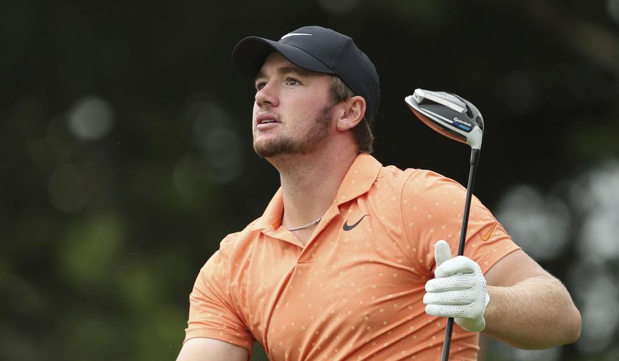 Sam Horsfield of England watches his tee shot during day two of the Celtic Classic at Celtic Manor Resort, Newport, Wales, Friday Aug. 14, 2020. (David Davies/PA via AP)