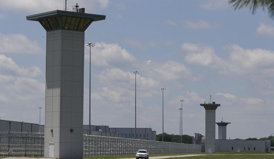 FILE - In this July 17, 2020, file photo the federal prison complex in Terre Haute, Ind., is shown. Indiana State Police agreed Friday, Aug. 14, 2020 to stop blocking roads to the prison where federal executions resumed last month and are set to continue, backing down after anti-death penalty activists said in a lawsuit the roadblocks impeded their speech rights. (AP Photo/Michael Conroy, File)