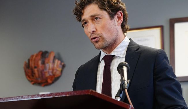 FILE - In this May 27, 2020, file photo, Minneapolis Mayor Jacob Frey calls on Hennepin County attorney Mike Freeman to charge the arresting officer in the death of George Floyd as he speaks during a news conference, at City Hall in Minneapolis. Mayor Frey on Friday, Aug. 14, 2020, announced plans to hold open 100 police officer positions next year as part of a hiring freeze to help manage a 2021 budget and as activists are clamoring to shift money away from traditional policing. (Evan Frost/Minnesota Public Radio via AP, File)