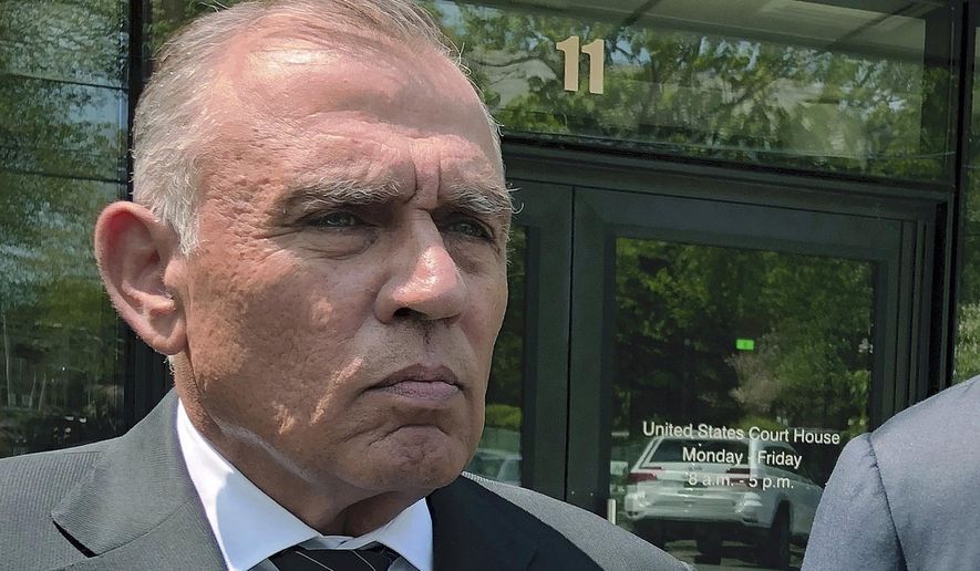 FILE - In this May 22, 2019, file photo, Ariel Quiros, left, former owner of Jay Peak Resort, stands outside the federal courthouse in Burlington, Vt., after his arraignment on fraud charges over a failed plan to build a biotechnology plant using foreign investors' money. The Miami businessman, accused of being the mastermind behind a massive fraud case involving foreign investors' money in Vermont developments, is expected to plead guilty in next week in a plea deal in which prosecutors are seeking a sentence of more than eight years in prison. (AP Photo/Lisa Rathke, File)