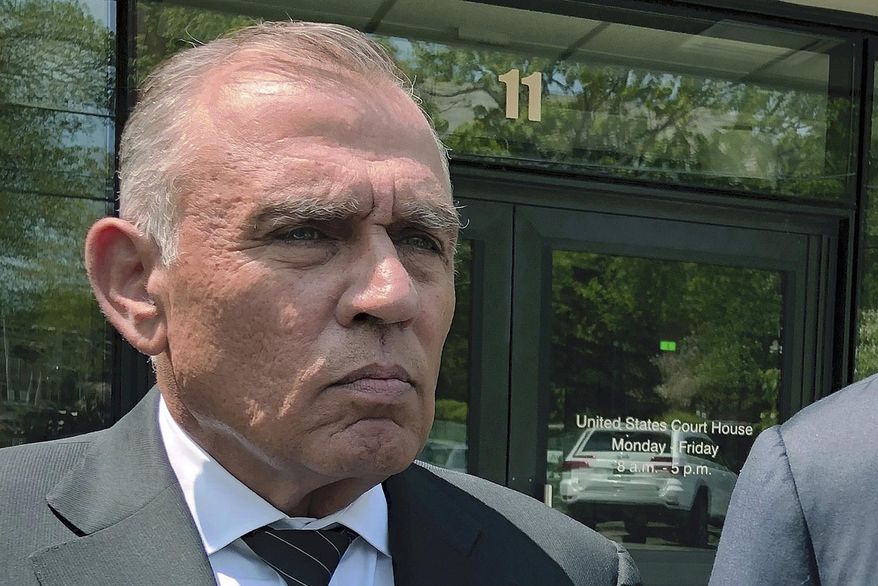 FILE - In this May 22, 2019, file photo, Ariel Quiros, left, former owner of Jay Peak Resort, stands outside the federal courthouse in Burlington, Vt., after his arraignment on fraud charges over a failed plan to build a biotechnology plant using foreign investors' money. The Miami businessman, accused of being the mastermind behind a massive fraud case involving foreign investors' money in Vermont developments, is expected to plead guilty in next week in a plea deal in which prosecutors are seeking a sentence of more than eight years in prison. (AP Photo/Lisa Rathke, File)