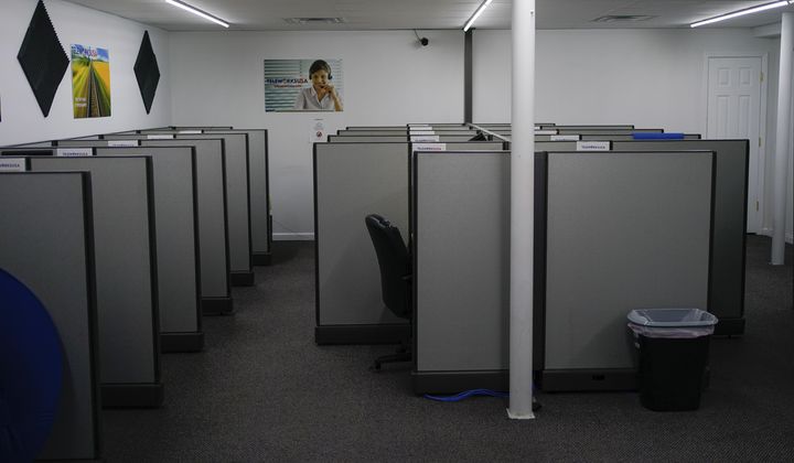 Unattended workstations fill the Teleworks USA job site in Beattyville, Ky., on Wednesday, July 29, 2020. The center is left dormant because of COVID-19 health concerns. (AP Photo/Bryan Woolston) ** FILE **