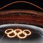 FILE - In this Aug. 13, 2004, file photo, the Olympic Rings are shown in flames in a pool of water during the Opening Ceremony of the 2004 Olympic Games in Athens. (AP Photo/Julie Jacobson, File)