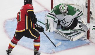 Calgary Flames&#39; Mikael Backlund (11) scores on Dallas Stars goalie Anton Khudobin (35) during the second period in the first round NHL Stanley Cup playoff hockey series, Friday, Aug. 14, 2020, in Edmonton, Alberta. (Jason Franson/The Canadian Press via AP)