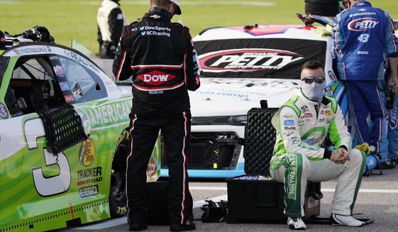 Driver Austin Dillon sits next to his car before a NASCAR Cup Series auto race at Kansas Speedway in Kansas City, Kan., Thursday, July 23, 2020. (AP Photo/Charlie Riedel)