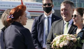 US Secretary of State Mike Pompeo, second right, and his wife Susan talk with US Ambassador to Poland Georgette Mosbacher, left, as they arrive at the airport in Warsaw, Poland, Saturday Aug. 15, 2020. Pompeo is on a five day visit to central Europe. (Janek Skarzynski/Pool via AP)