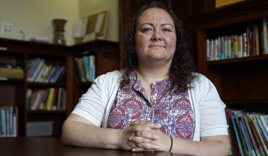Dr. Michelle LaRue sits for a portrait in Hyattsville, Md., on Wednesday, Aug. 12, 2019. LaRue is a manager at CASA de Maryland, an immigration advocacy group that has partnered with health officials in Prince George's County just outside of Washington. D.C., to make the calls to Spanish speakers. She said earning trust begins with hiring contact tracers who not only speak Spanish but also intimately understand immigrant communities. (AP Photo/Julio Cortez)