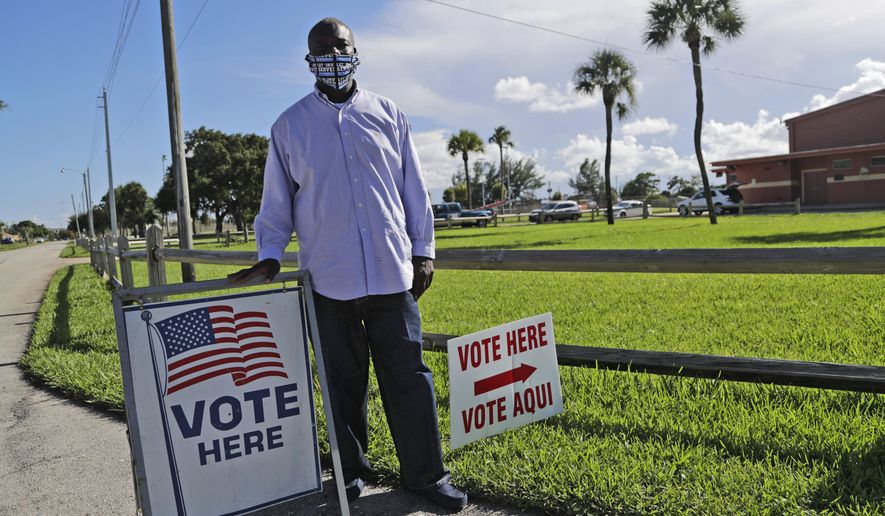 William Freeman, 51, poses for a photograph outside of his polling station, Monday, Aug. 10, 2020, in Riviera Beach, Fla. Freeman recently registered to vote after serving three years for grand theft, his fourth prison stint. (AP Photo/Lynne Sladky)