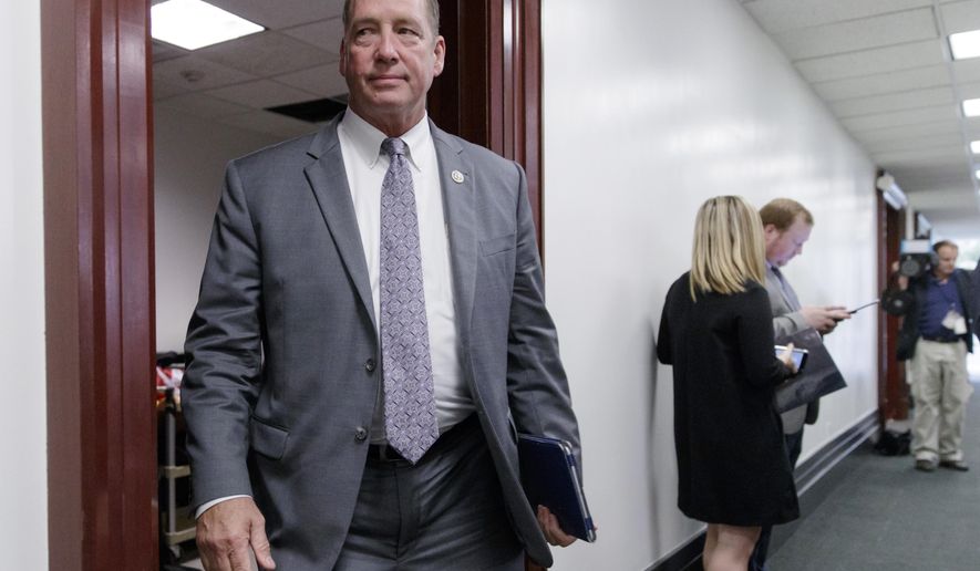 FILE - In this March 28, 2017, file photo, Rep. Ted Yoho, R-Fla., leaves a closed-door strategy session at the Capitol in Washington. Florida will elect at least two new members of Congress this year, and the Republican primaries in two districts will likely decide who they'll be. Republican U.S. Reps. Ted Yoho is leaving office in a heavily GOP district. Yoho' s District 3 stretches from Ocala to just south of Jacksonville. (AP Photo/J. Scott Applewhite, File)