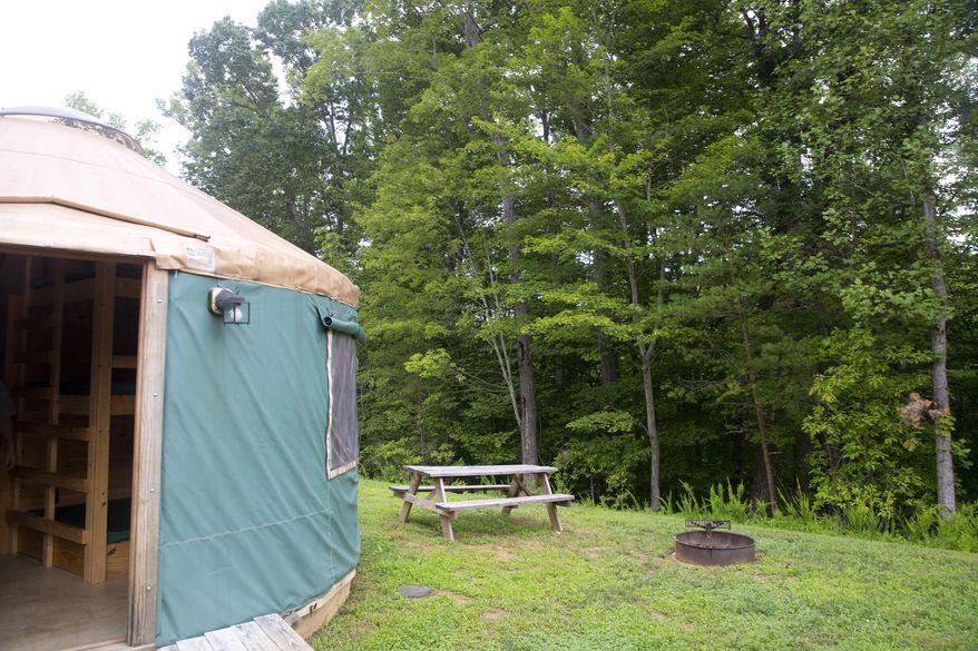 Each rental space at Explore Park features a picnic table and fire pit at Don's Cab-Inns Campground, Aug. 6, 2020, in Roanoke, Va. Don Harrison said he’s only been in business at Explore Park for about two years, so he was expecting an uptick in traffic as more people learned about his offerings. But the number of people booking stays is far more than he anticipated, which he believes is because of the pandemic. (Stephanie Klein-Davis/The Roanoke Times via AP)