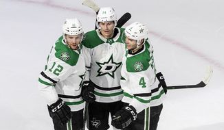 Dallas Stars&#39; Radek Faksa (12), Denis Gurianov (34) and Miro Heiskanen (4) celebrate a goal against the Calgary Flames during second-period NHL Western Conference Stanley Cup hockey playoff action in Edmonton, Alberta, Sunday, Aug. 16, 2020. (Jason Franson/The Canadian Press via AP)