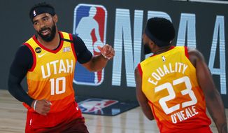 Utah Jazz&#x27; Mike Conley (10)  celebrates a three-point basket with teammate Royce O&#x27;Neale (23) against the Denver Nuggets during the first quarter of an NBA basketball game Saturday, Aug. 8, 2020, in Lake Buena Vista, Fla. (Kevin C. Cox/Pool Photo via AP)