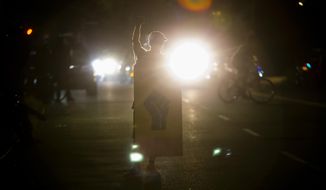Police declared a riot around midnight as Portland protests continued for the 80th consecutive night Saturday, Aug. 15, 2020. Protesters gathered at Laurelhurst Park Saturday evening before marching to the Penumbra Kelly building.  (Dave Killen/The Oregonian via AP)