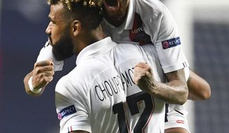 PSG&#39;s Neymar celebrates with teammate Eric Maxim Choupo-Moting after his team&#39;s win in the Champions League quarterfinal match between Atalanta and PSG at Luz stadium, Lisbon, Portugal, Wednesday, Aug. 12, 2020. (David Ramos/Pool Photo via AP)