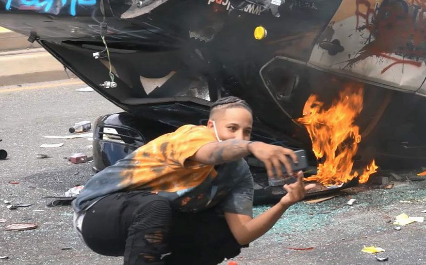 Federal prosecutors in Utah said they identified a person on video in front of a burning police car as Lateesha Richards. Ms. Richards now faces charges, as do other people detected through technology. (Photo courtesy of the U.S. attorney’s office)
