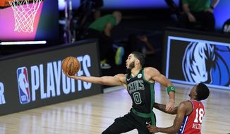 Boston Celtics&#39; Jayson Tatum (0) shoots as Philadelphia 76ers&#39; Shake Milton (18) defends during the second half of an NBA basketball first round playoff game Monday, Aug. 17, 2020, in Lake Buena Vista, Fla. (AP Photo/Ashley Landis, Pool)