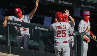 St. Louis Cardinals&#x27; Dexter Fowler (25) celebrates in the dugout after his home run in the third inning of Game 1 of a baseball doubleheader against the Chicago Cubs, Monday, Aug. 17, 2020, in Chicago. (AP Photo/Matt Marton)