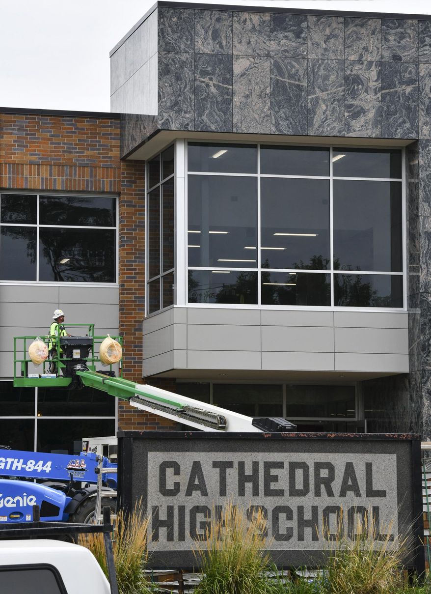 Work continues at the site of the new Cathedral High School academic building Monday, Aug. 10, 2020, in St. Cloud, Minn. “This new building is coming at the perfect time to be able to give Cathedral extra space. The whole idea of this building was to be able to have flexible space, more collaboration space, room to spread out,” said Marit Ortega, director for the Campaign for Cathedral. (Dave Schwarz/St. Cloud Times via AP)