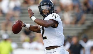 FILE - In this Sept. 6, 2019, file photo, then-Wake Forest quarterback Jamie Newman (12) looks to pass during an NCAA football game in Houston. Two transfers, Jamie Newman, from Wake Forest, and JT Daniels, from Southern Cal, are names to watch in Georgia’s five-player quarterback competition. Newman may be the favorite as practice started Monday because Daniels is still recovering from a knee injury at USC. (AP Photo/Matt Patterson, File)