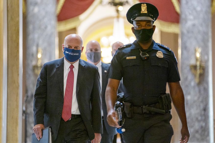 FILE - In this Aug. 5, 2020, file photo Postmaster General Louis DeJoy, left, is escorted to House Speaker Nancy Pelosi's office on Capitol Hill in Washington. Several individuals including candidates for public office sued President Donald Trump and the U.S. Postal Service's new postmaster general in New York on Monday, Aug. 17, 2020 to ensure adequate funding for postal operations. The lawsuit was filed in Manhattan federal court as multiple lawsuits were threatened across the country as a response to comments the president recently made and actions taken by DeJoy to change operations at post offices nationwide. (AP Photo/Carolyn Kaster, File)