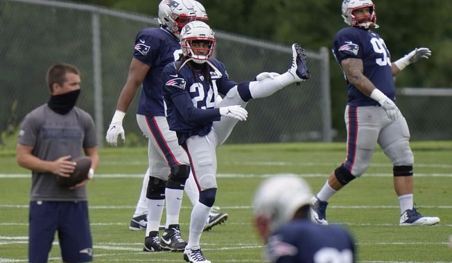 New England Patriots cornerback Stephon Gilmore (24) stretches during an NFL football training camp practice, Monday, Aug. 17, 2020, in Foxborough, Mass. (AP Photo/Steven Senne, Pool)