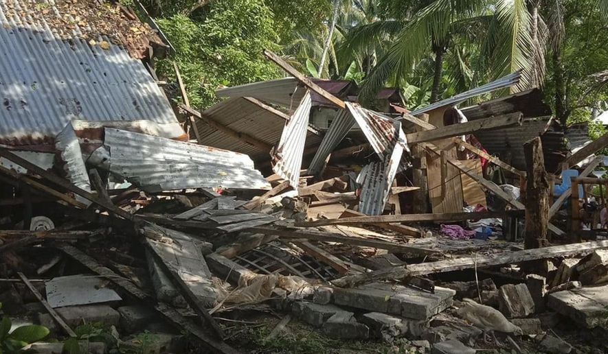In this photo provided by the Philippine Red Cross, a toppled house is seen after a quake struck in Cataingan, Masbate province, central Philippines on Tuesday Aug. 18, 2020. A powerful and shallow earthquake struck a central Philippine region Tuesday, prompting people to dash out of homes and offices but there were no immediate reports of injuries or major damage. (John Mark Lalaguna/Philippine National Red Cross via AP)