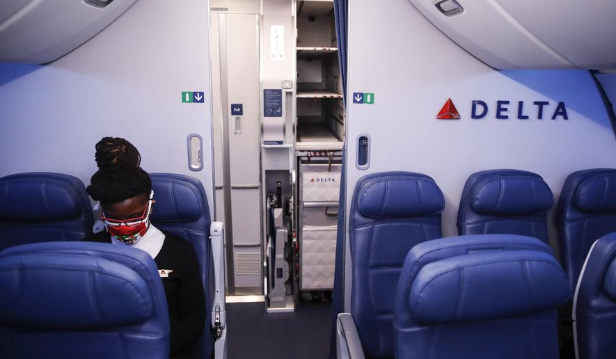 In this May 28, 2020, file photo, a Delta Airlines employee wears personal protective equipment after landing at Minneapolis−Saint Paul International Airport, in Minneapolis. Airlines are trying to convince a frightened public that measures like mandatory face masks and hospital-grade air filters make sitting in a plane safer than many other indoor settings during the coronavirus pandemic, but it isn’t working. (AP Photo/John Minchillo, File)